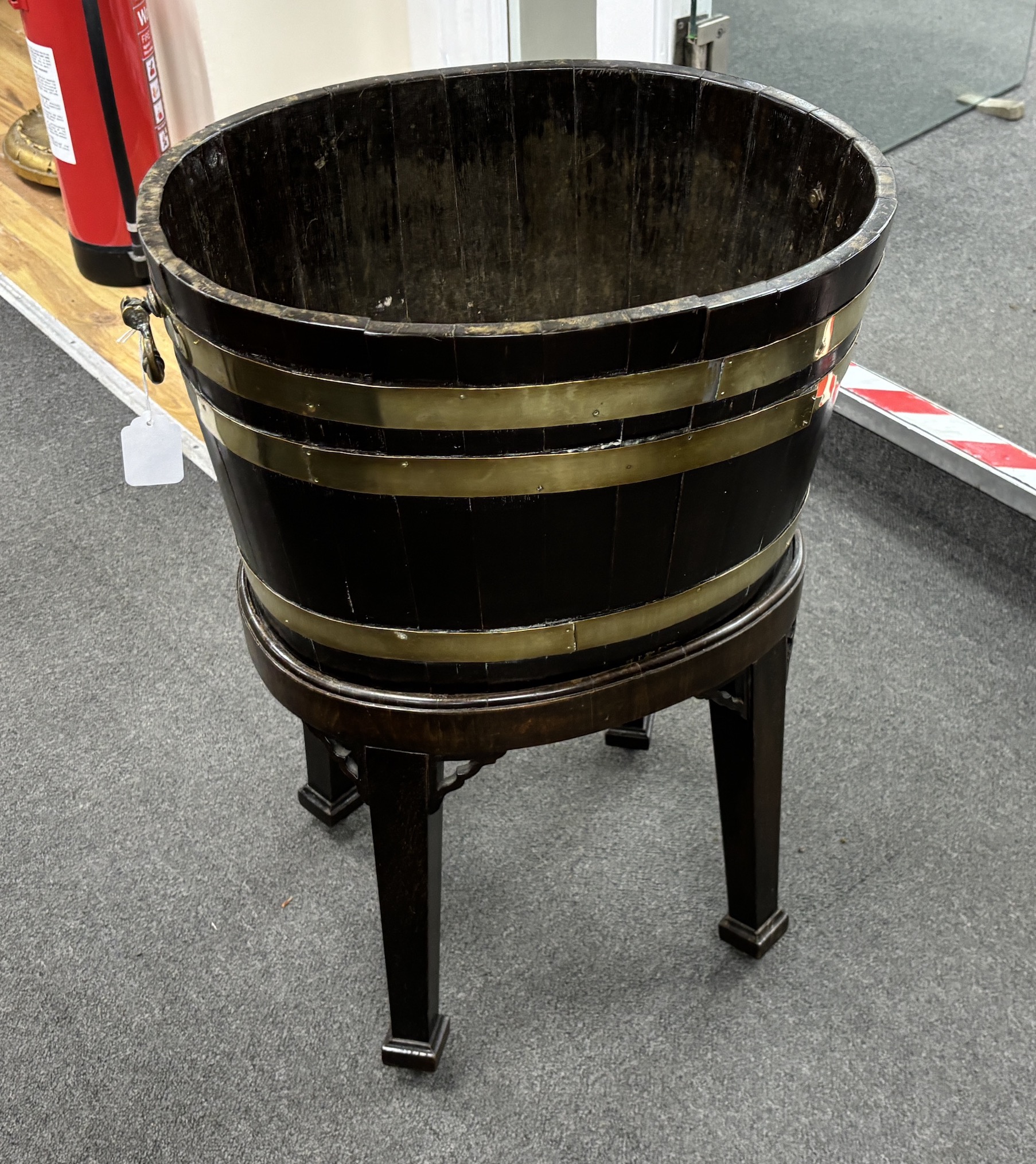 A George III triple brass bound mahogany wine cooler, on a detachable stand, width 48cm, depth 38cm, height 69cm
